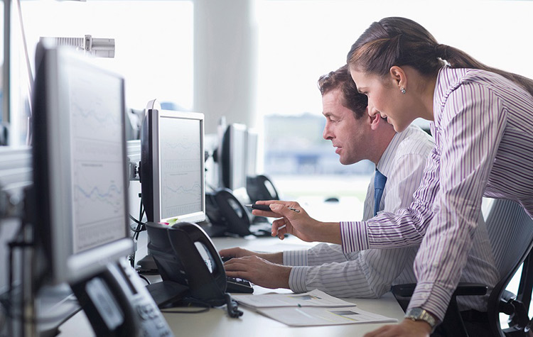 Business Frau sitzt im Büro vor ihrem Rechner